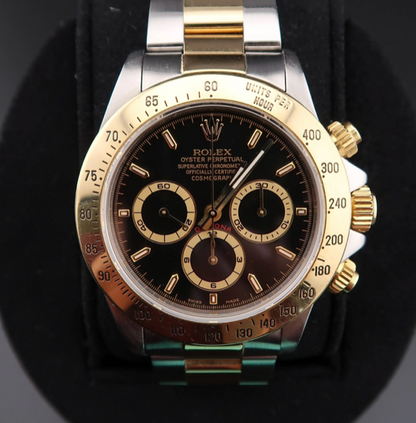 Luxury watch with a black face and gold accents on a dark background